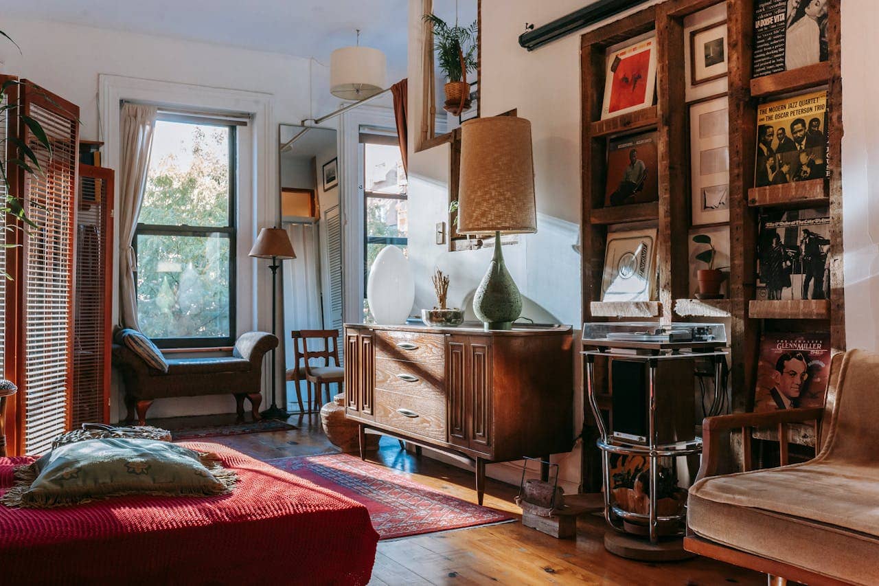 Budget-friendly living room with painted dresser, reupholstered chair, and DIY wall art.
