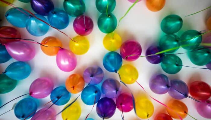 Family celebrating a birthday with handwritten notes, balloons, and heartfelt traditions