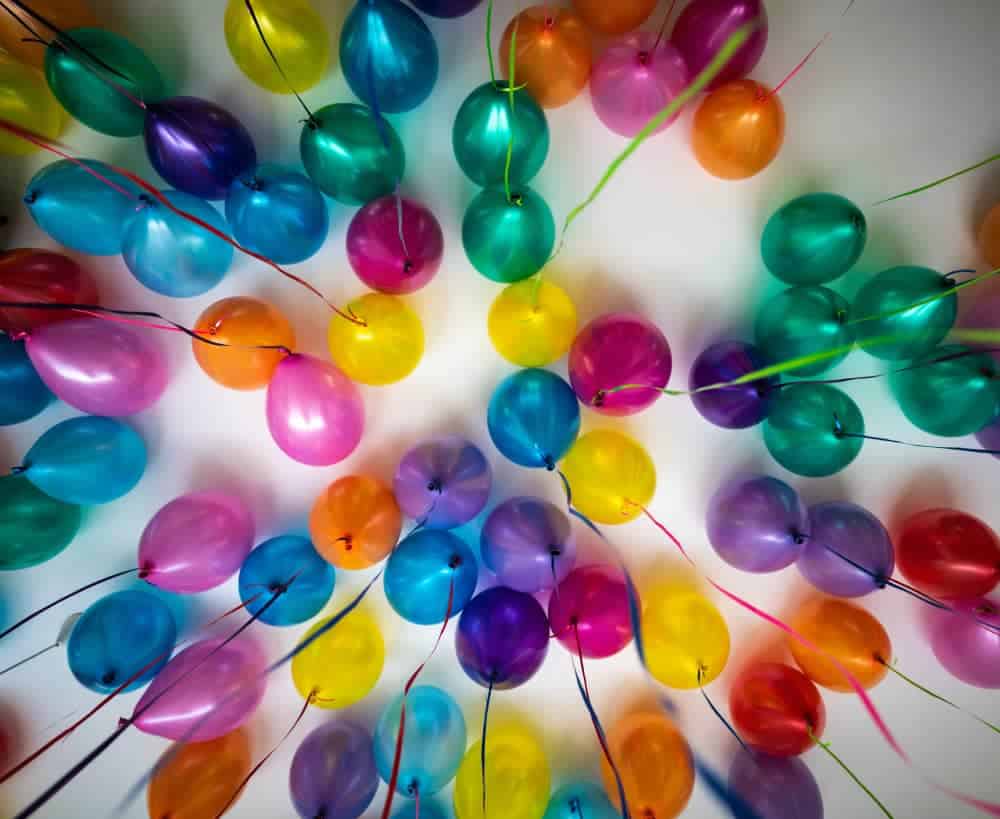 Family celebrating a birthday with handwritten notes, balloons, and heartfelt traditions